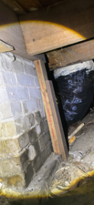 Improper structural support using a wooden 2X4 in crawl space