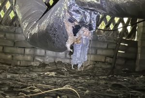 Picture of damaged ductwork and insulation