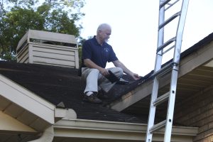 Home inspector examining a roof